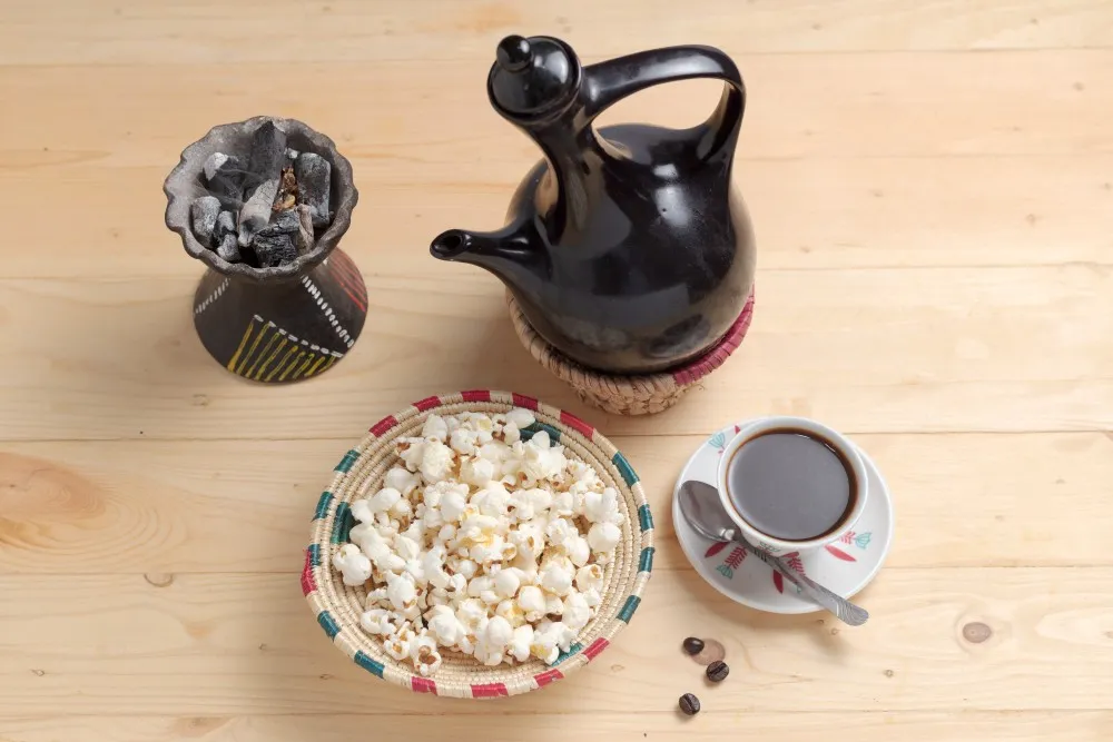Pouring traditional Ethiopian coffee from a jebena pot