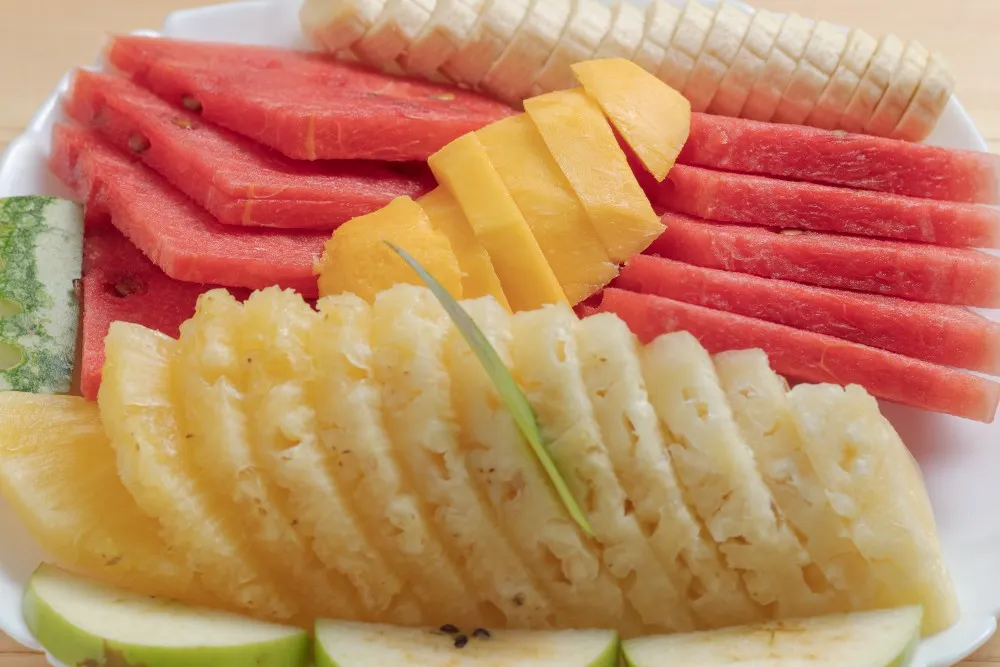 Intimate romantic dining setting with fresh fruit platter in Entebbe